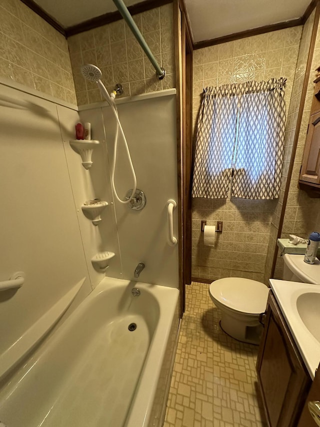 full bathroom with vanity,  shower combination, tile walls, crown molding, and toilet