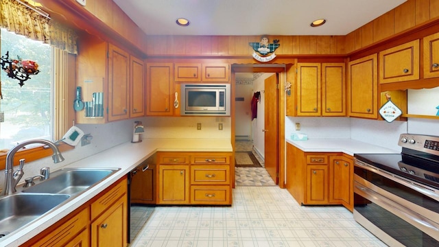 kitchen with a wealth of natural light, sink, and appliances with stainless steel finishes