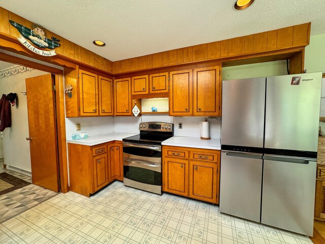 kitchen featuring appliances with stainless steel finishes and a textured ceiling