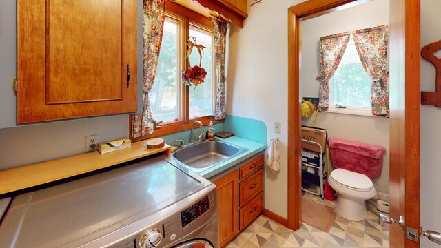 interior space featuring washer / clothes dryer, a healthy amount of sunlight, and sink