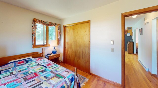 bedroom featuring light wood-type flooring and a closet