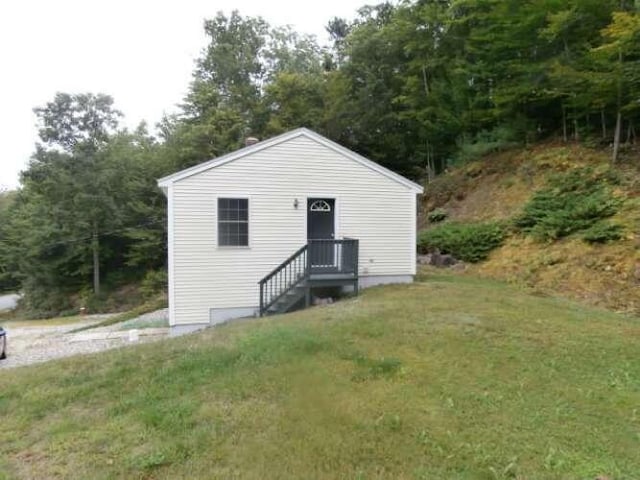 view of outbuilding with a lawn