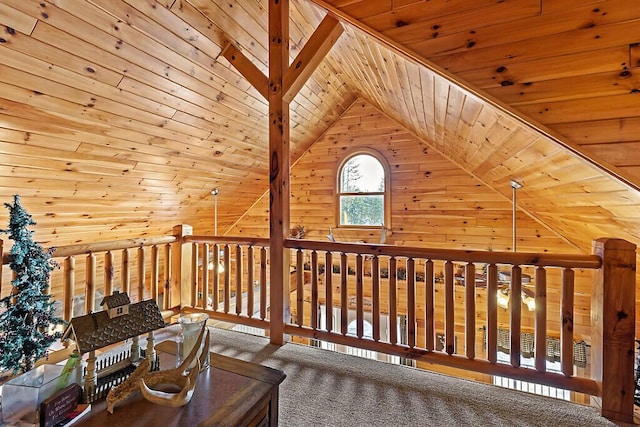 interior space with lofted ceiling, wood walls, wooden ceiling, and carpet floors