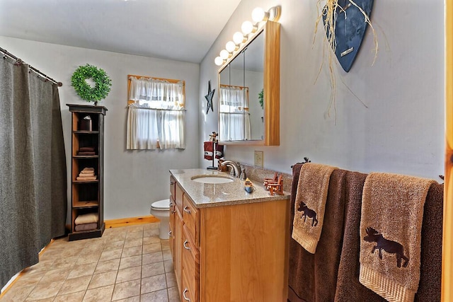 full bathroom featuring toilet, tile patterned flooring, and vanity