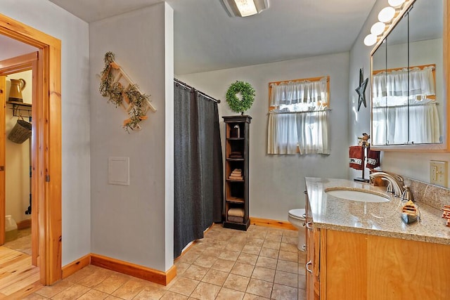 bathroom featuring a shower with shower curtain, tile patterned floors, vanity, and toilet