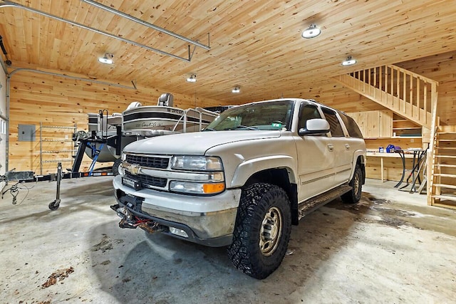 garage with wooden ceiling and wooden walls