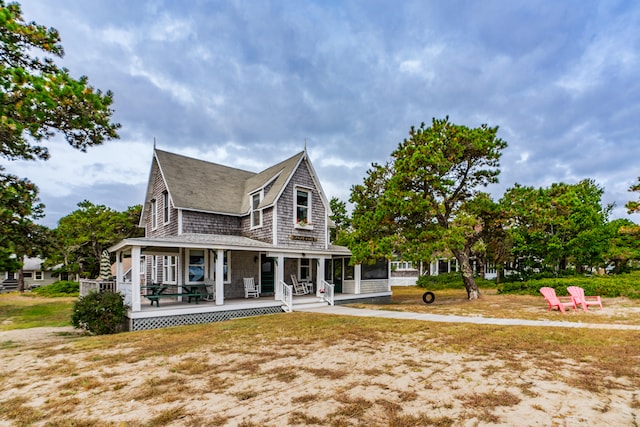 back of property with covered porch