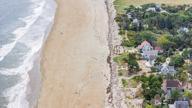 birds eye view of property featuring a water view and a view of the beach