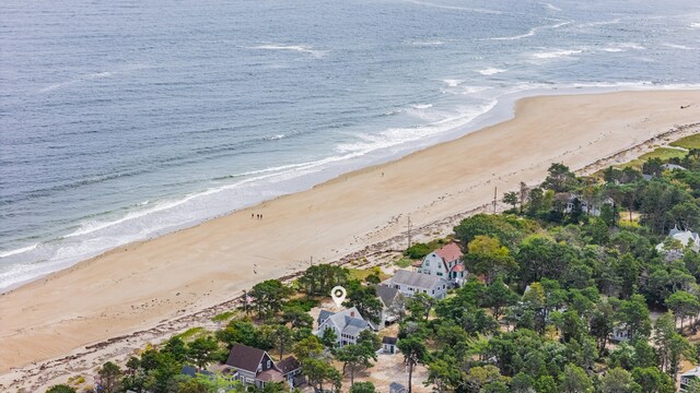 birds eye view of property featuring a beach view and a water view