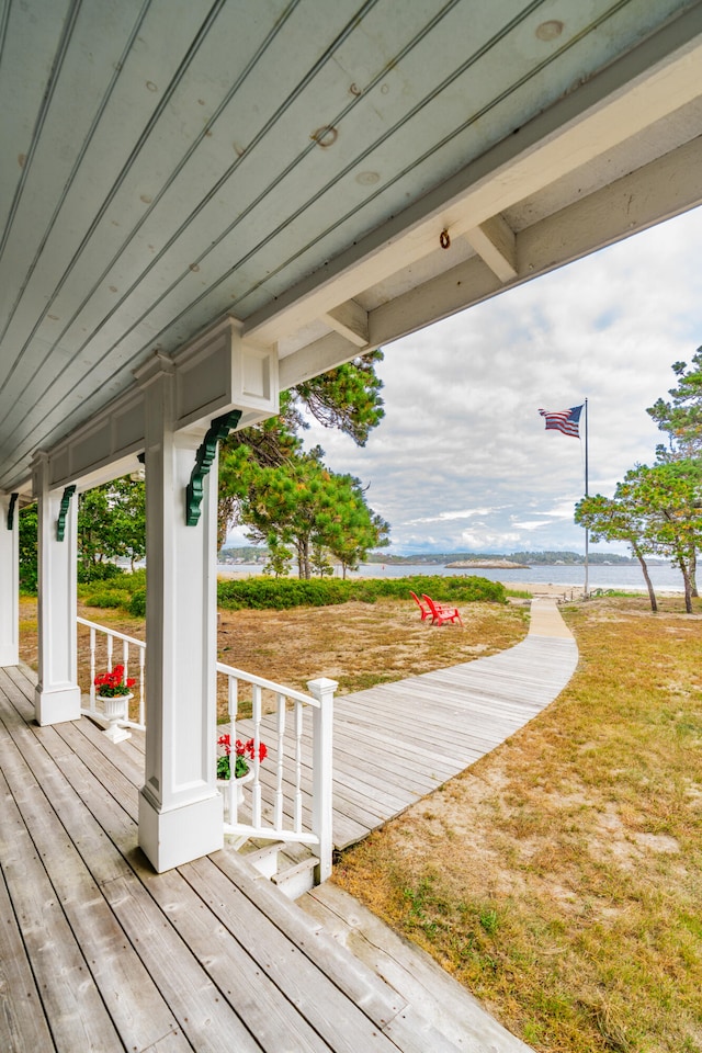 wooden deck featuring a water view