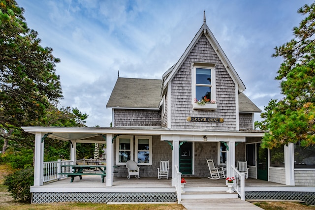 rear view of property featuring a porch