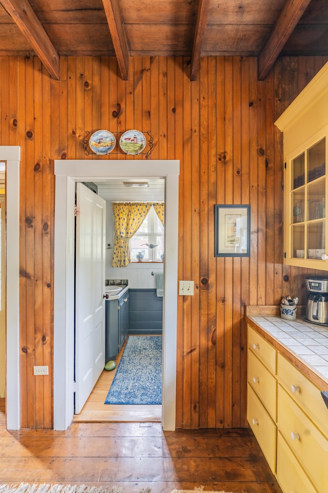 kitchen featuring tile counters, wood walls, and wood-type flooring