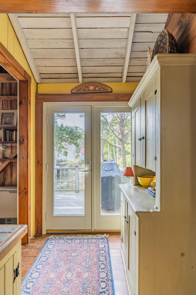 interior space with vaulted ceiling with beams, wood ceiling, and light hardwood / wood-style floors