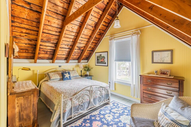 bedroom with vaulted ceiling with beams, wood ceiling, and light hardwood / wood-style flooring