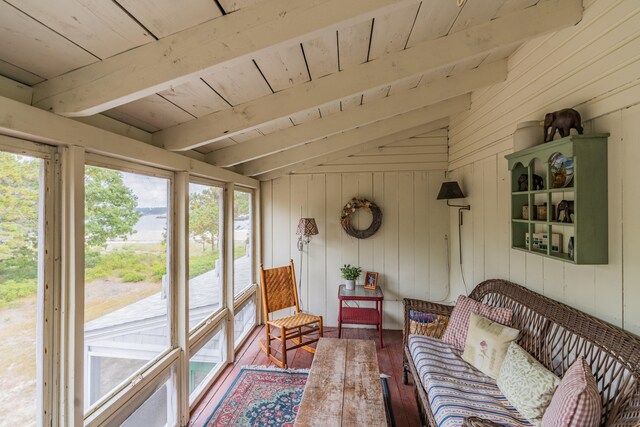 sunroom / solarium with vaulted ceiling with beams, wooden ceiling, and a wealth of natural light