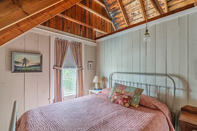 bedroom with wooden walls and lofted ceiling