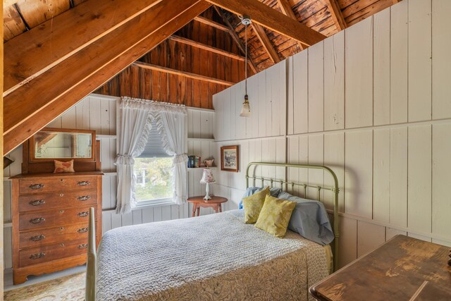 unfurnished bedroom featuring wooden ceiling, wood walls, and lofted ceiling with beams