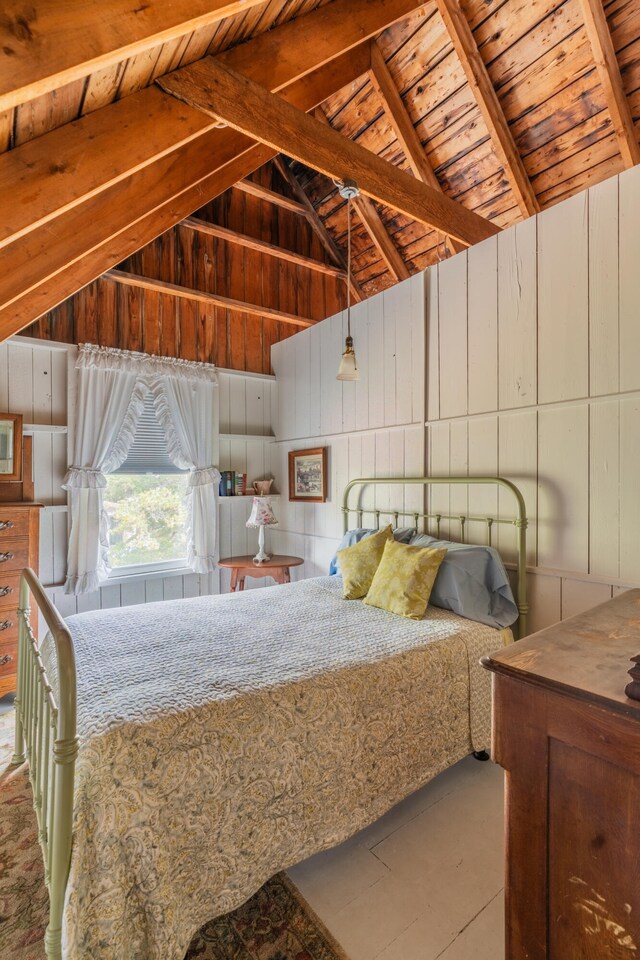 bedroom featuring lofted ceiling with beams, wooden walls, and wooden ceiling