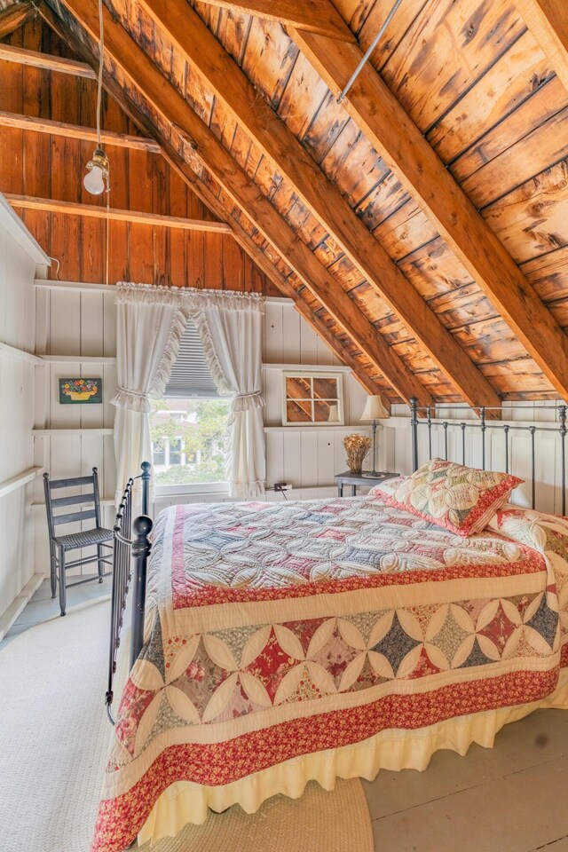 bedroom featuring wood ceiling and vaulted ceiling with beams