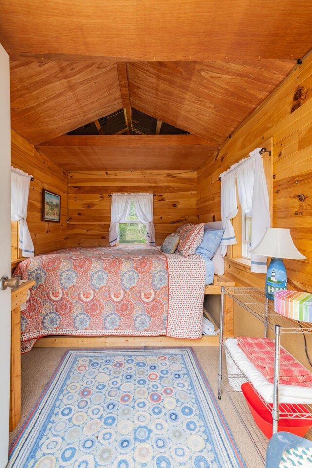 bedroom with wooden walls and lofted ceiling