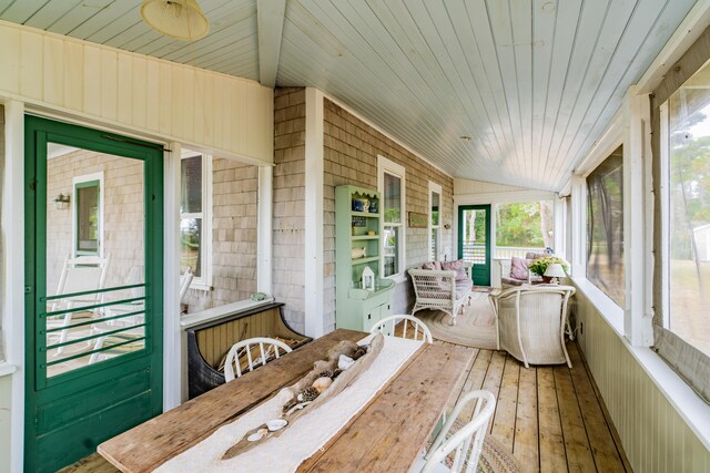 sunroom with vaulted ceiling and wooden ceiling