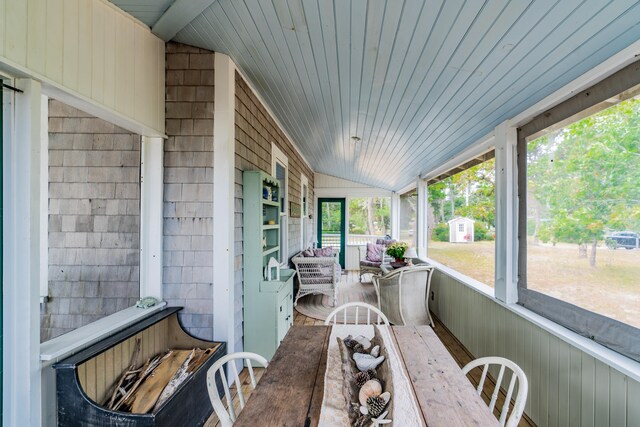 sunroom featuring wooden ceiling, lofted ceiling, and a wealth of natural light