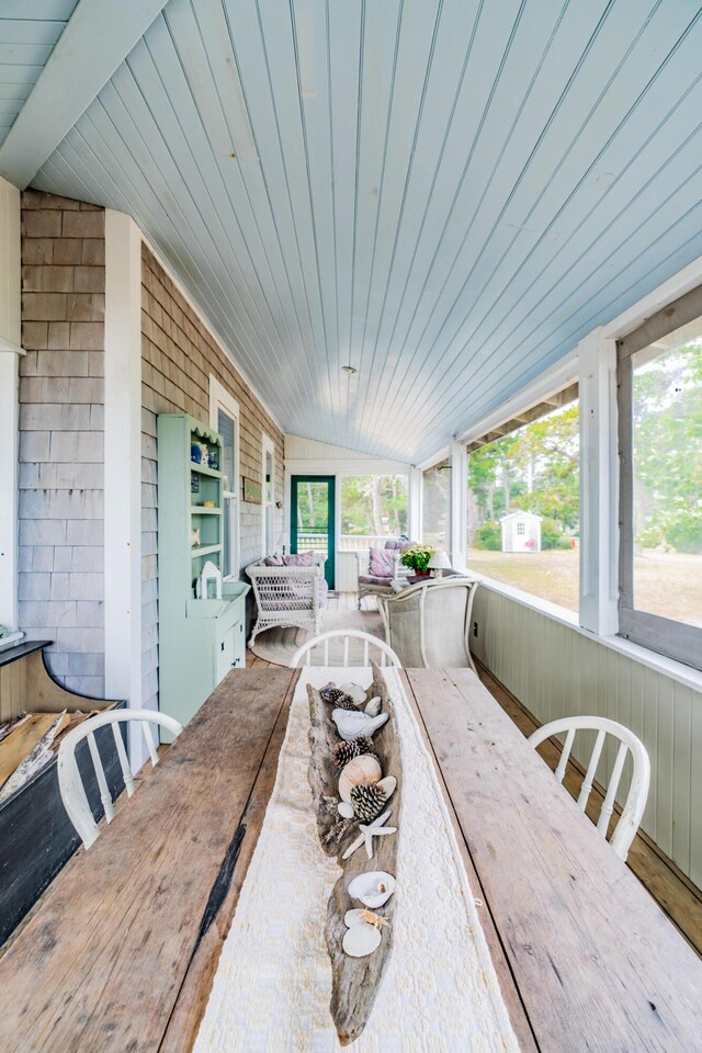 exterior space with wooden ceiling, lofted ceiling, and plenty of natural light