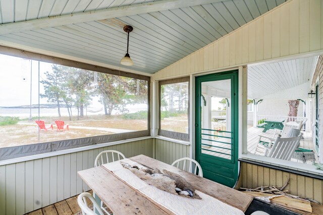 sunroom featuring lofted ceiling with beams