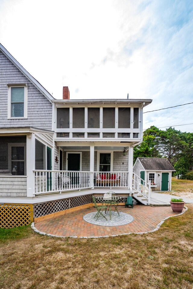 back of house with a yard and a patio area