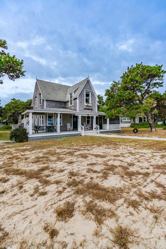 rear view of house featuring a porch