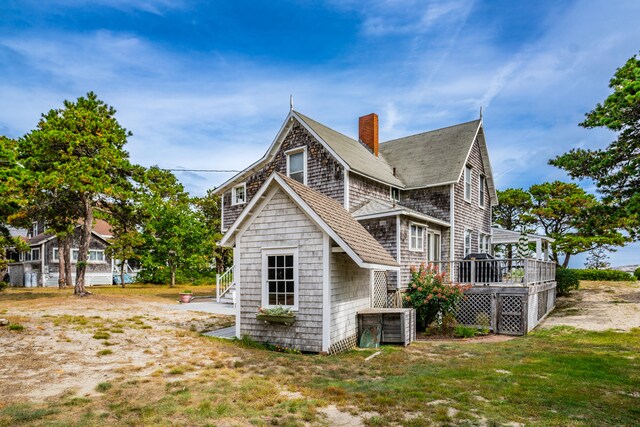 view of home's exterior with a wooden deck and central AC