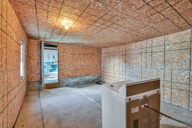 spare room featuring unfinished concrete flooring