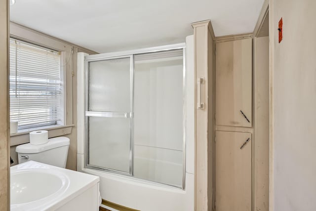 full bathroom featuring enclosed tub / shower combo, toilet, and vanity