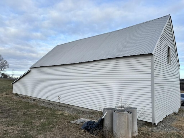 view of home's exterior with an outbuilding and metal roof