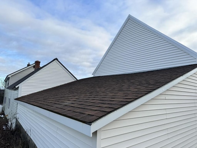 exterior details with roof with shingles