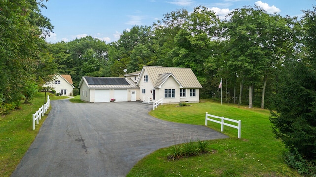 view of front of property featuring a garage and a front yard