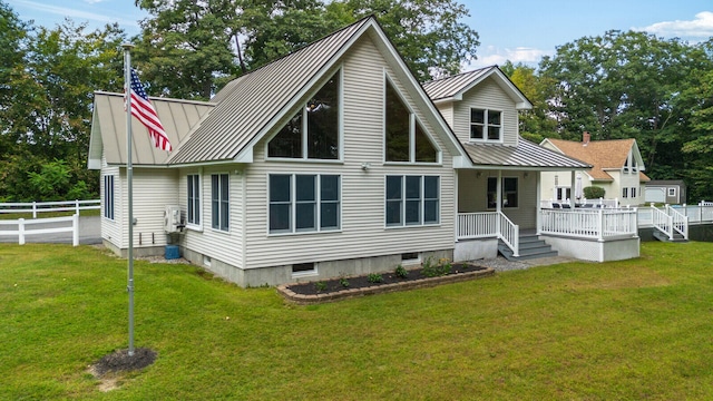 back of property featuring a lawn