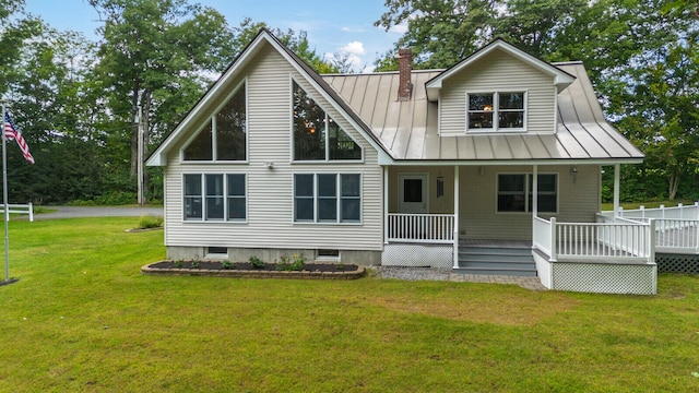 rear view of house featuring a yard