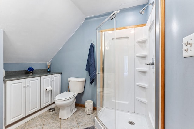 bathroom featuring lofted ceiling, toilet, a shower with shower door, and tile patterned flooring