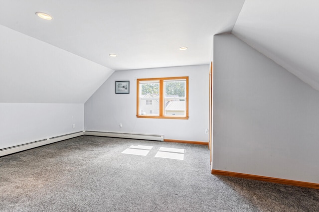 additional living space featuring carpet flooring, baseboard heating, and vaulted ceiling