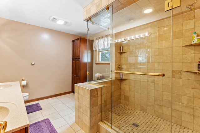 bathroom featuring vanity, toilet, walk in shower, and tile patterned floors