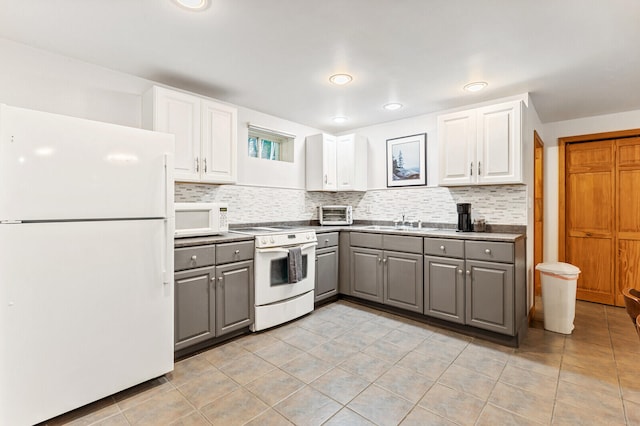 kitchen featuring white cabinetry, white appliances, gray cabinetry, and decorative backsplash