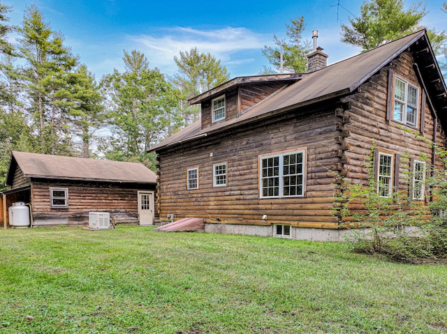 rear view of property with a yard