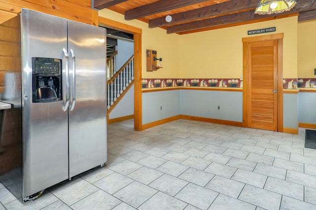 kitchen featuring beam ceiling, stainless steel fridge with ice dispenser, light tile patterned floors, and wooden ceiling