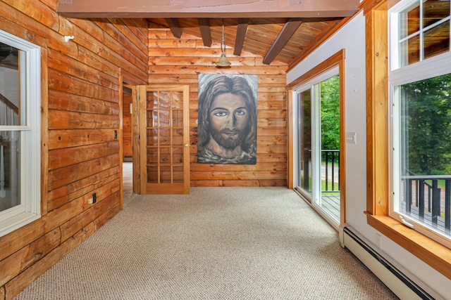 carpeted spare room featuring wooden ceiling, vaulted ceiling with beams, and a baseboard heating unit