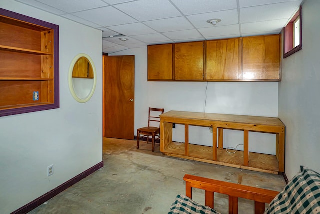 basement with a paneled ceiling