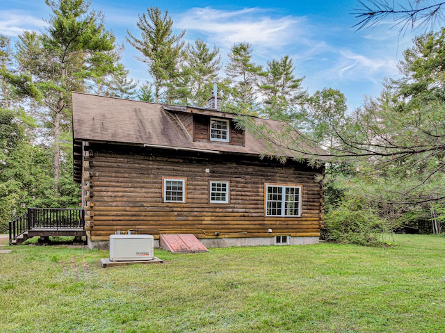 rear view of property featuring a yard and a wooden deck