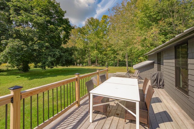 wooden terrace with a lawn