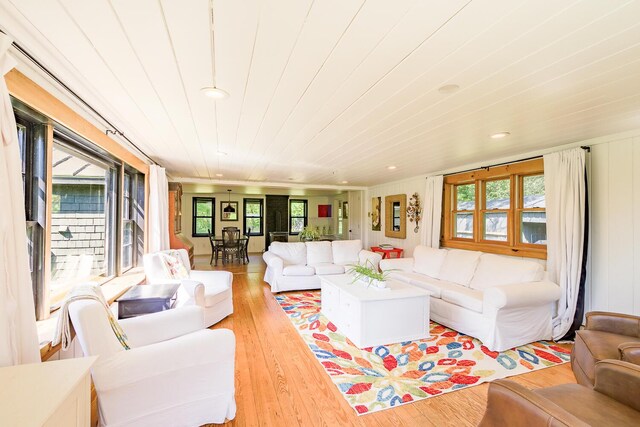 living room featuring wood ceiling and light hardwood / wood-style flooring