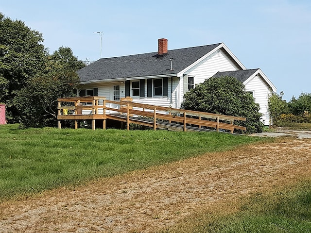 rear view of property with a yard and a deck